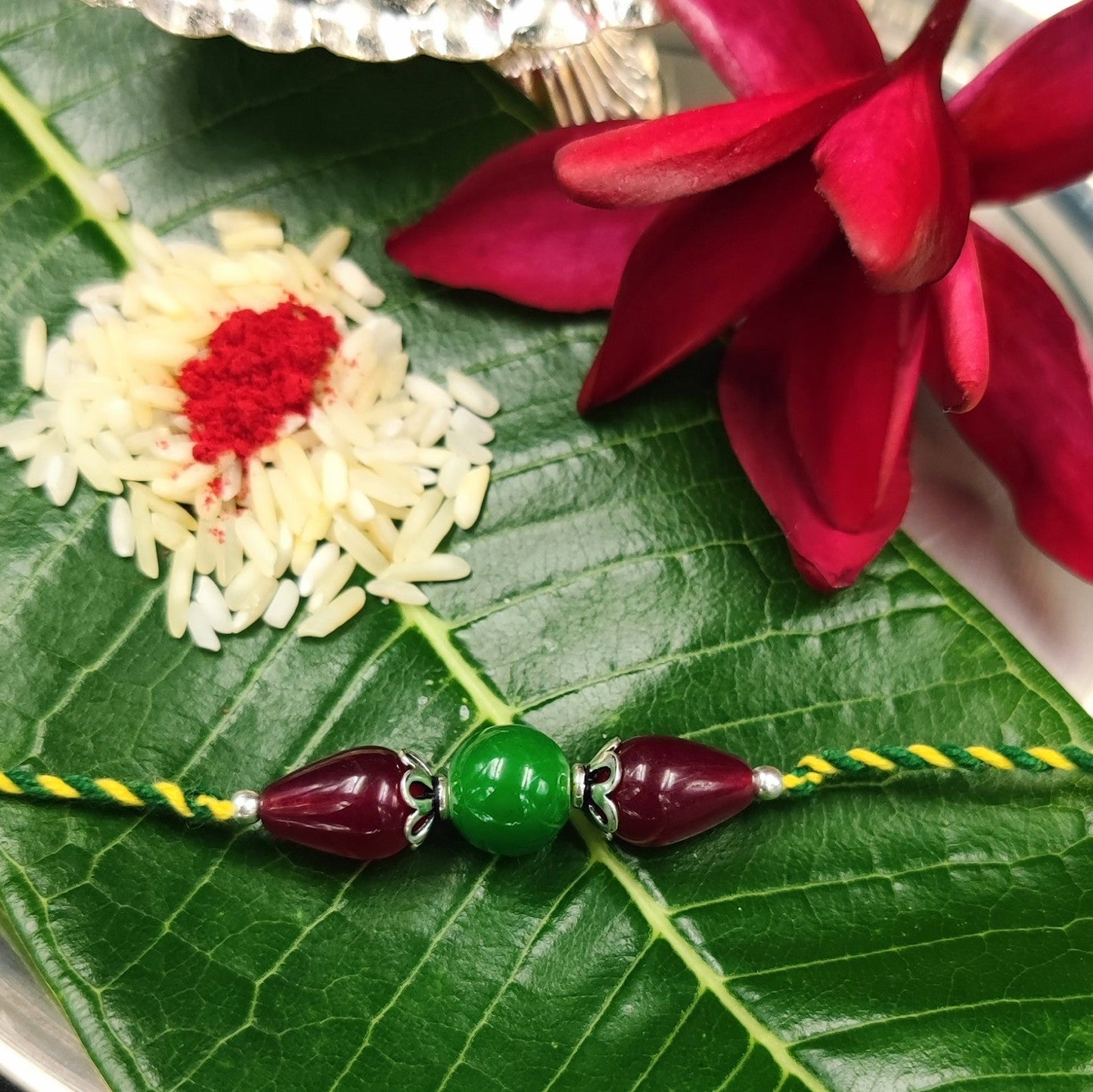 Silver Jewelry Rakhi by Jauhri 92.5 Silver Rakshabandhan Special - Green Pink Bloom Rakhi