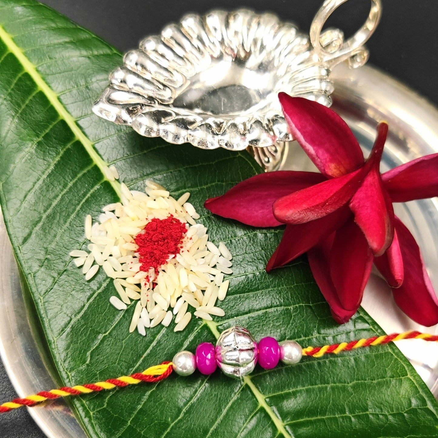 Silver Jewelry Rakhi by Jauhri 92.5 Silver Rakshabandhan Special - Pink Flower Bead Rakhi