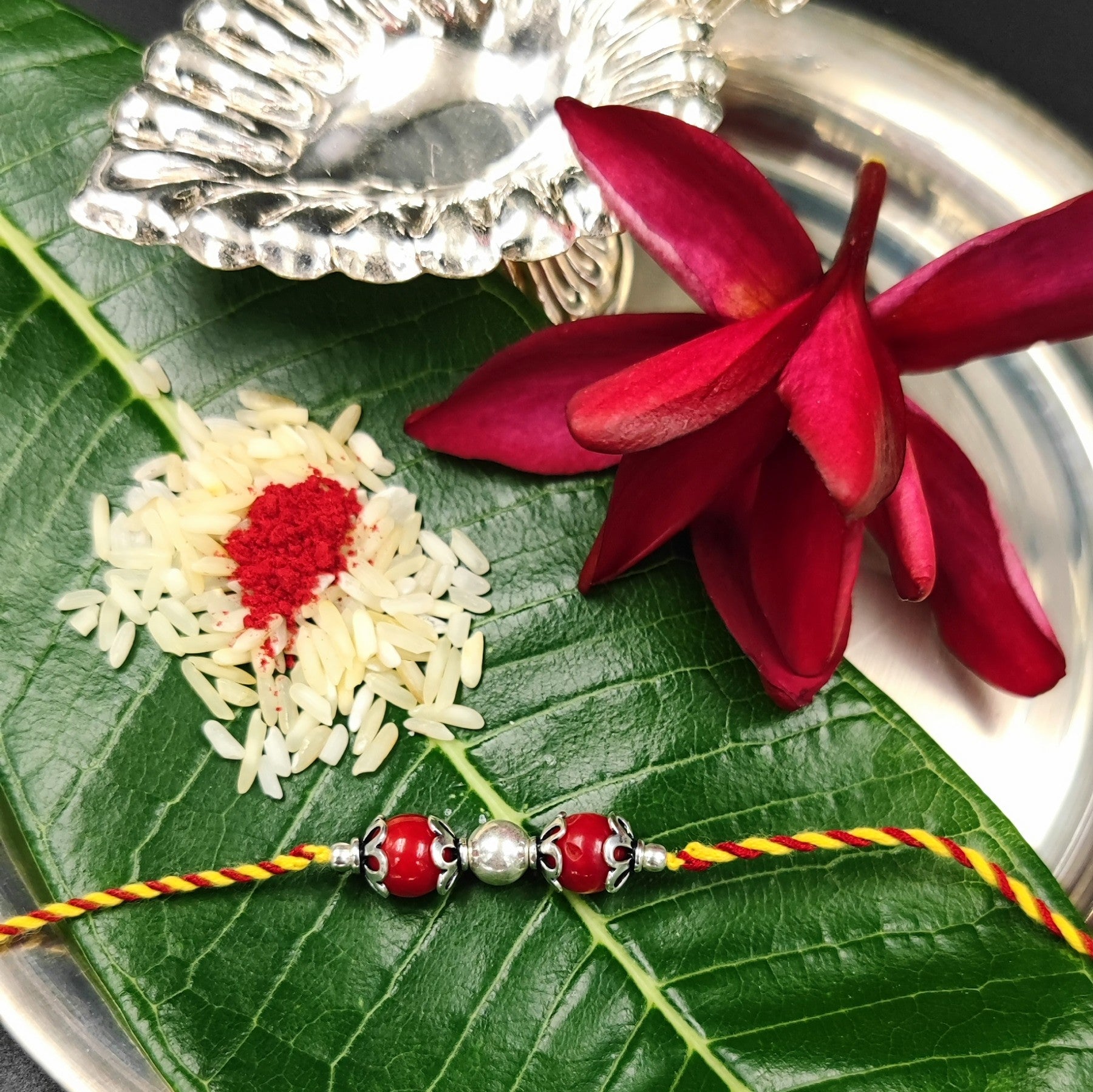Silver Jewelry Rakhi by Jauhri 92.5 Silver Rakshabandhan Special - Red Bead Rakhi